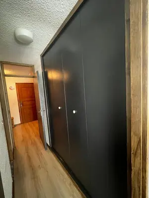 a room with a black wall and a hallway at Le Carolaz Studio cosy et familial pour 4 personnes in Les Contamines-Montjoie
