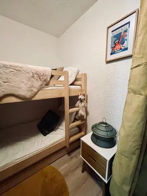 a room with two bunk beds with a pot on a table at Le Carolaz Studio cosy et familial pour 4 personnes in Les Contamines-Montjoie