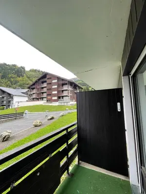 a balcony with a black gate and a building at Le Carolaz Studio cosy et familial pour 4 personnes in Les Contamines-Montjoie