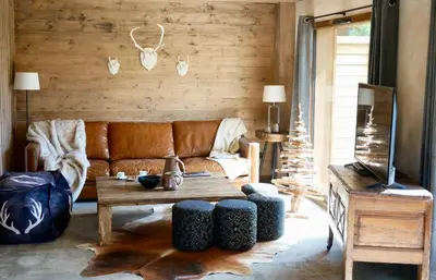 a living room with a couch and a table at Appartement Panthère in Demi-Quartier