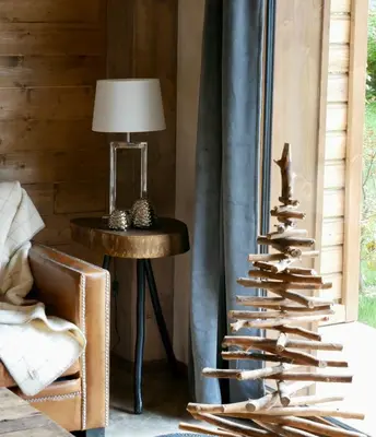 a christmas tree on a table next to a chair at Appartement Panthère in Demi-Quartier