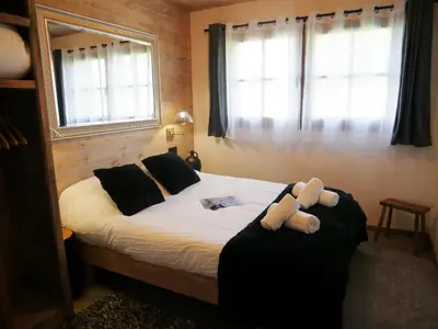 a bedroom with a bed with a teddy bear on it at Appartement Panthère in Demi-Quartier