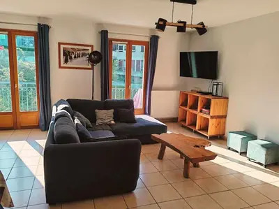 a living room with a couch and a coffee table at Appartement familial en résidence Saint Gervais les bains in Saint-Gervais-les-Bains