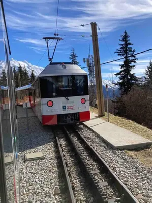 a train on the tracks near a train station at Appartement familial en résidence Saint Gervais les bains in Saint-Gervais-les-Bains