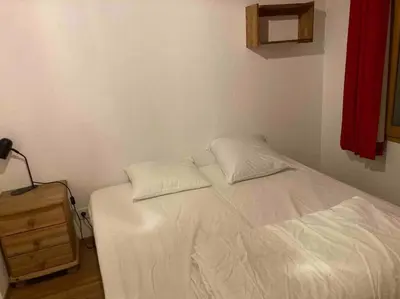 a bedroom with a bed with two pillows on it at Appartement familial en résidence Saint Gervais les bains in Saint-Gervais-les-Bains