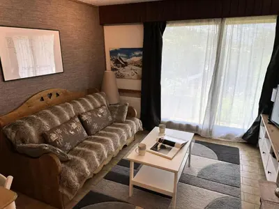 a living room with a couch and a coffee table at Résidence Ecrin Des Glacier Ecureuil - ECRIN DES GLACIERS ECUREUIL 4 MAE-4011 in Combloux