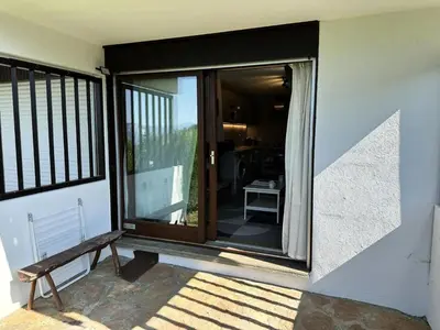 a sliding glass door with a bench on a porch at Résidence Ecrin Des Glacier Ecureuil - ECRIN DES GLACIERS ECUREUIL 4 MAE-4011 in Combloux