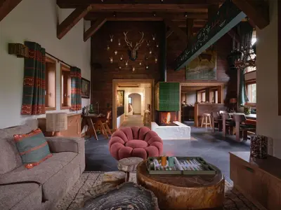 a living room with a couch and a table at Chalet Molitor, avec services, Collection Chalets des Fermes in Megève