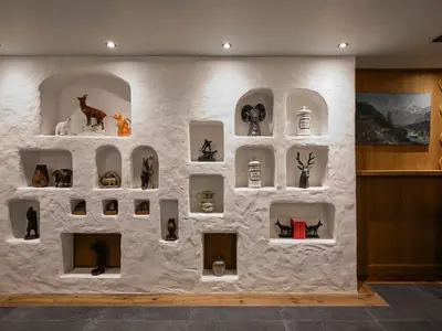 a wall with many figurines on it in a room at Chalet Molitor, avec services, Collection Chalets des Fermes in Megève