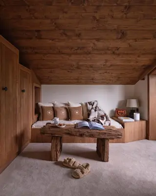 a living room with a couch and a wooden ceiling at Chalet Molitor, avec services, Collection Chalets des Fermes in Megève