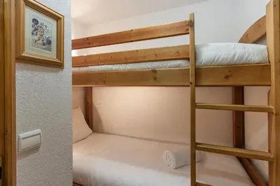 a couple of bunk beds in a small room at Les Carlines in Les Contamines-Montjoie