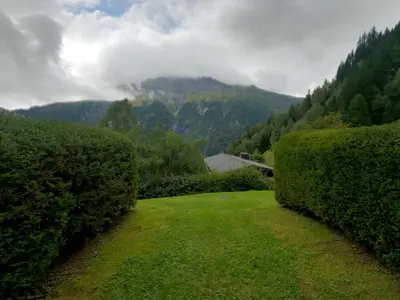 a hedge yard with a view of a mountain at Les Carlines in Les Contamines-Montjoie