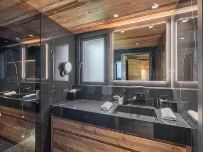 a bathroom with a sink and a mirror at Chalet d'Exception à Megève avec Piscine et Cinéma - FR-1-569-194 in Megève