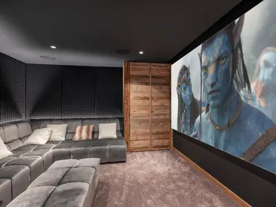 a living room with a couch and a large painting at Chalet d'Exception à Megève avec Piscine et Cinéma - FR-1-569-194 in Megève