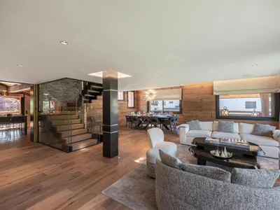 a living room with couches and a dining room at Chalet d'Exception à Megève avec Piscine et Cinéma - FR-1-569-194 in Megève