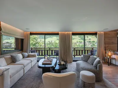 a living room with a couch and chairs and windows at Chalet d'Exception à Megève avec Piscine et Cinéma - FR-1-569-194 in Megève