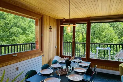 a living room with a table and chairs at Comfort nature and exceptional Mont Blanc view in Chamonix-Mont-Blanc