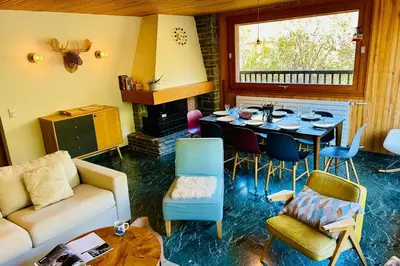 a living room with a couch and a table at Comfort nature and exceptional Mont Blanc view in Chamonix-Mont-Blanc