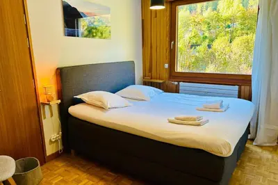 a kitchen with white cabinets and tile walls at Comfort nature and exceptional Mont Blanc view in Chamonix-Mont-Blanc