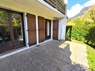 a house with glass doors and a patio at Résidence Vallée Blanche in Sallanches