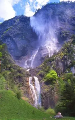 a waterfall on the side of a mountain at Résidence Vallée Blanche in Sallanches