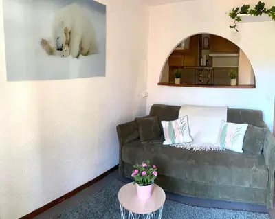 a living room with a couch and a polar bear on the wall at Résidence Vallée Blanche in Sallanches