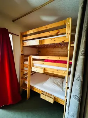 a bunk bed in a room with a bed in a room at Studio vue montagne à 200m des pistes in Arâches-la-Frasse