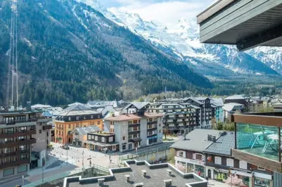 a view of a city with mountains in the background at Two bedroom apartment, Hypercenter, terrace Mont Blanc, parking in Chamonix-Mont-Blanc
