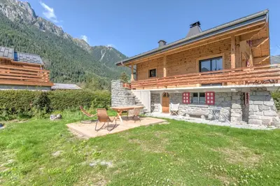 a house with a table and chairs in the yard at Appartement Couttet - Welkeys in Chamonix-Mont-Blanc