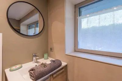 a bathroom with a sink and a mirror at Appartement Couttet - Welkeys in Chamonix-Mont-Blanc