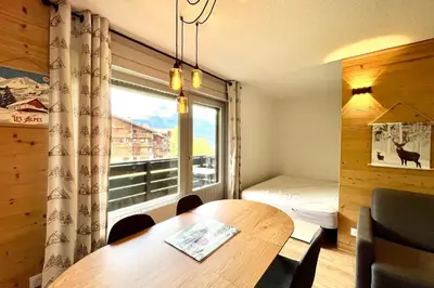a room with a table and a window and a bed at Cozy Joly in Saint-Gervais-les-Bains