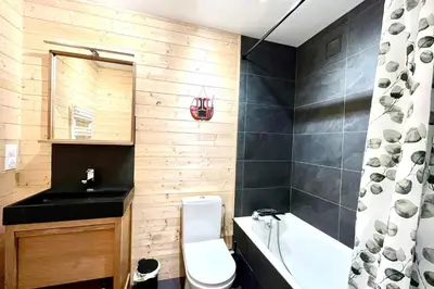 a bathroom with a toilet and a sink and a tub at Cozy Joly in Saint-Gervais-les-Bains