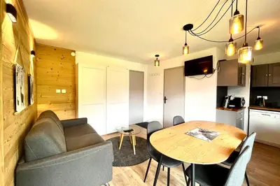 a living room with a table and a couch at Cozy Joly in Saint-Gervais-les-Bains