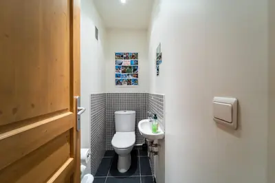 a small bathroom with a toilet and a sink at Bright apartment - near Mont Blanc in Chamonix-Mont-Blanc