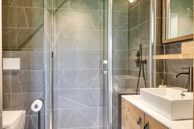 a bathroom with a shower and a sink at Charmant Appartement au Cœur de Megève avec Jardin privatif in Megève