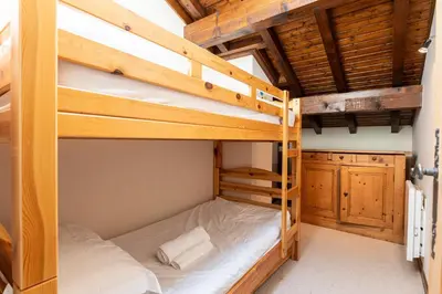 a bunk bed room with two bunk beds in a cabin at Chalet Cleo - charmant chalet 180 m2 avec vue montagne in Samoëns