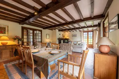 a kitchen and living room with a table and chairs at Chalet Cleo - charmant chalet 180 m2 avec vue montagne in Samoëns