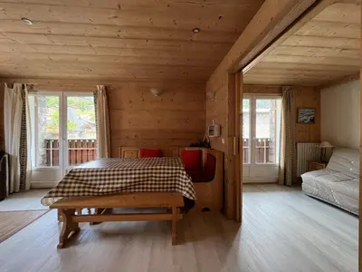 a bedroom with a bed in a wooden house at ARA15 Appartement 6 Pers centre station Carroz in Les Carroz d'Araches