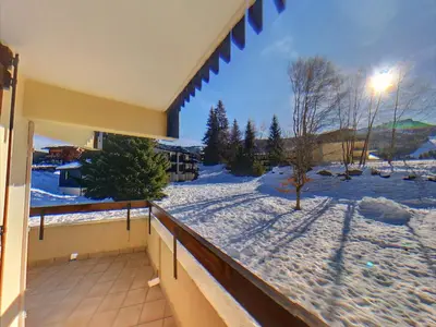 a balcony with a view of a snow covered yard at AT101 Appartement 6 Pers proche base de loisirs in Les Carroz d'Araches