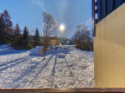 a snow covered yard with a tree and a street light at AT101 Appartement 6 Pers proche base de loisirs in Les Carroz d'Araches