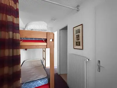 a small room with two bunk beds in it at AT101 Appartement 6 Pers proche base de loisirs in Les Carroz d'Araches