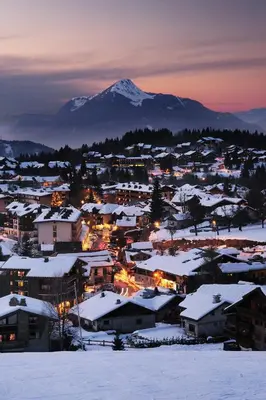 a town covered in snow with a mountain in the background at AT101 Appartement 6 Pers proche base de loisirs in Les Carroz d'Araches