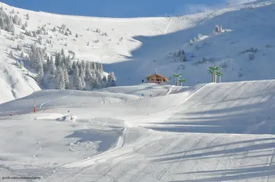 a snow covered mountain with a house in the background at AM104 Duplex 8 Pers centre des Carroz in Les Carroz d'Araches