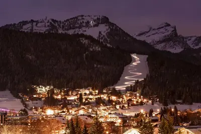 a view of a town in the snow at night at AM104 Duplex 8 Pers centre des Carroz in Les Carroz d'Araches