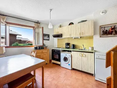 a kitchen with a stove and a dishwasher at AM104 Duplex 8 Pers centre des Carroz in Les Carroz d'Araches