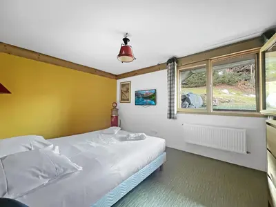 a bedroom with a white bed and a window at CH719 - Chalet 10 Pers aux Carroz in Les Carroz d'Araches