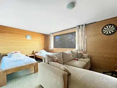 a living room with a couch and a bed at CH719 - Chalet 10 Pers aux Carroz in Les Carroz d'Araches