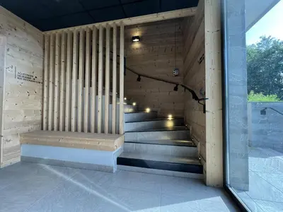a staircase in a building with a wooden wall at GCB103 Appartement 10 personnes in Les Carroz d'Araches