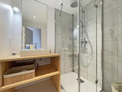 a bathroom with a sink and a shower at GCB103 Appartement 10 personnes in Les Carroz d'Araches