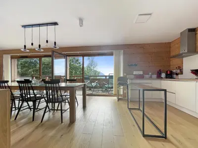 a kitchen and dining room with a table and chairs at GCB103 Appartement 10 personnes in Les Carroz d'Araches